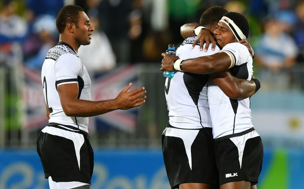 Fiji's players celebrate victory in the men’s rugby sevens gold medal match between Fiji and Britain during the Rio 2016 Olympic Games at Deodoro Stadium in Rio de Janeiro on August 11, 2016.