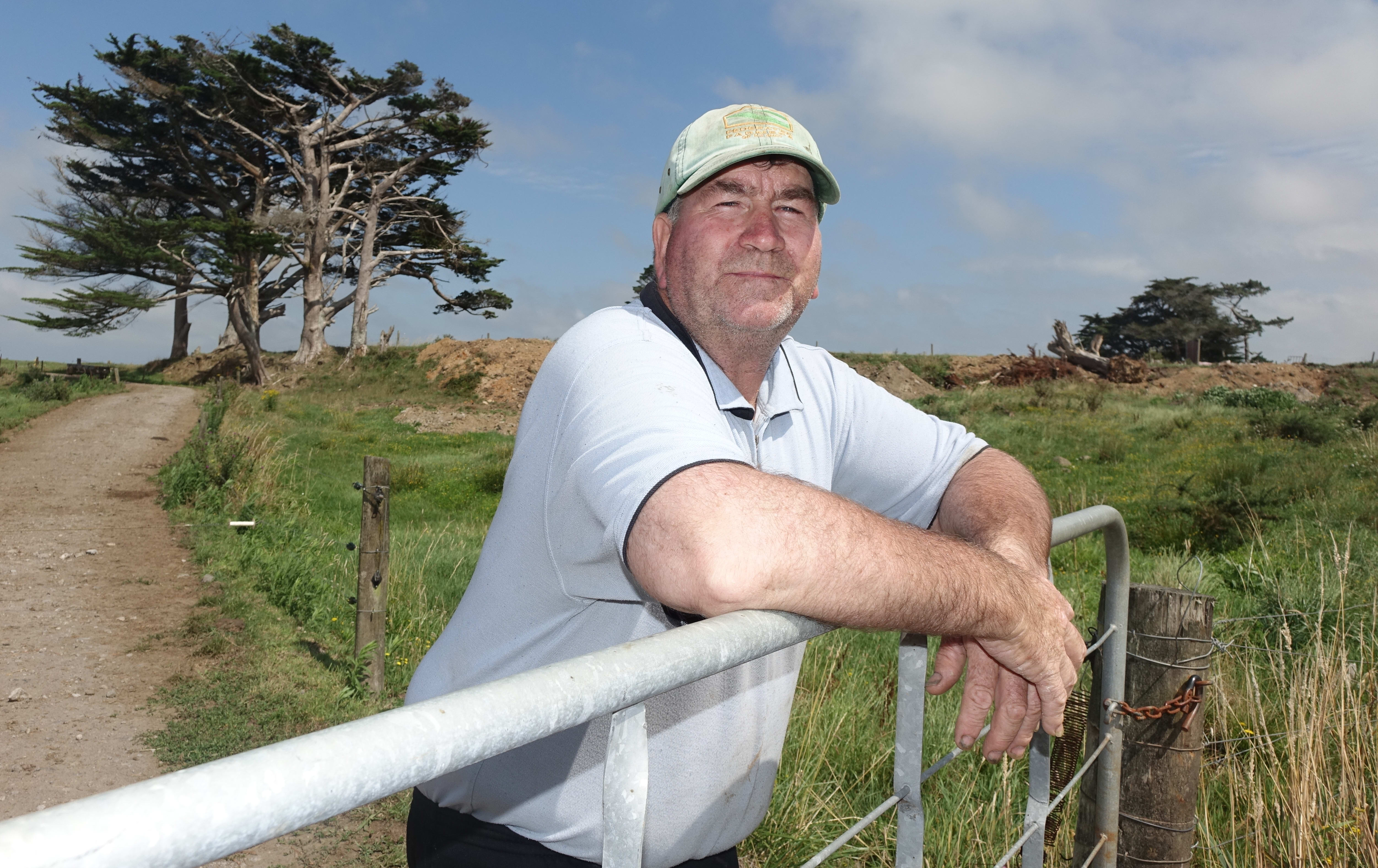 Opunake farmer Kerry Smith leaning on a fence.