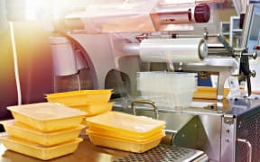 Industrial equipment for food packaging in factory.