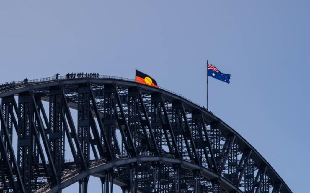 Aboriginal flag flies alongside Australian flag on Sydney Harbour Bridge. Photo courtesy Jason Edwards