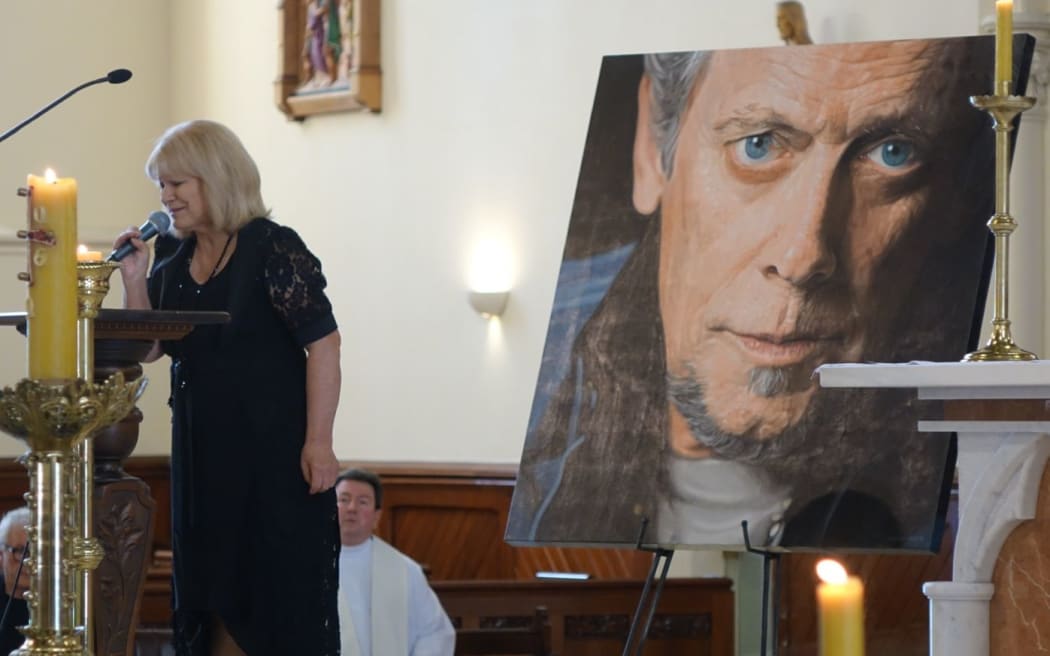 Suzanne Lynch sings wind beneath my wings at ray Columbus funeral.