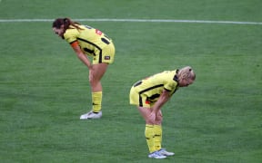 Phoenix' Mackenzie Barry with Betsy Hassett stand dejected