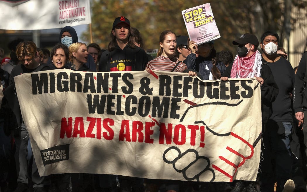 Human rights activists protest in opposition to a Stop Immigration Rally organised by The National Socialist Network outside of Parliament House in Melbourne on May 13, 2023. (Photo by Martin KEEP / AFP)