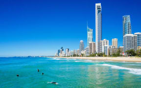 Surfers catching waves in  Surfers Paradise on the Gold Coast, QLD, Australia