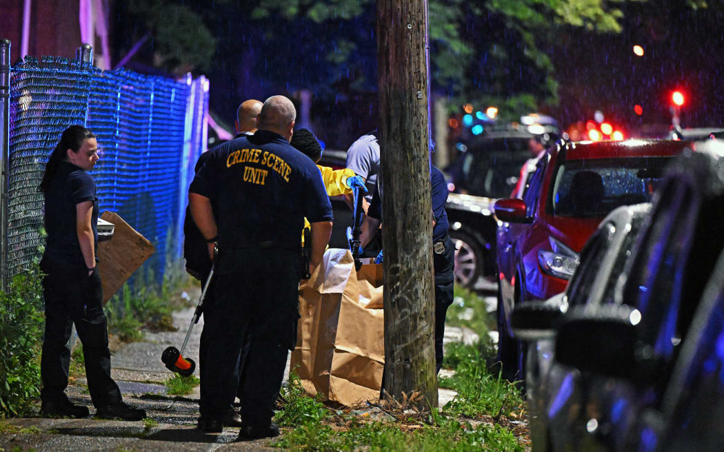 Police place a rifle in a bag on the scene of a shooting on July 3, 2023 in Philadelphia, Pennsylvania. Early reports say the suspect is in custody after shooting 6 people in the Kingsessing section of Philadelphia on July 3rd.