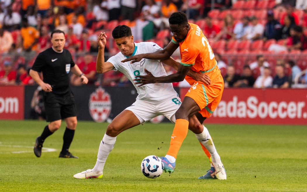Marko Stamenic contests possession for the All Whites against Ivory Coast.