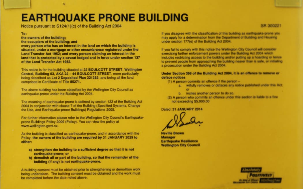 Yellow sticker on the Dominion Post Building on Boulcott Street, Wellington.
