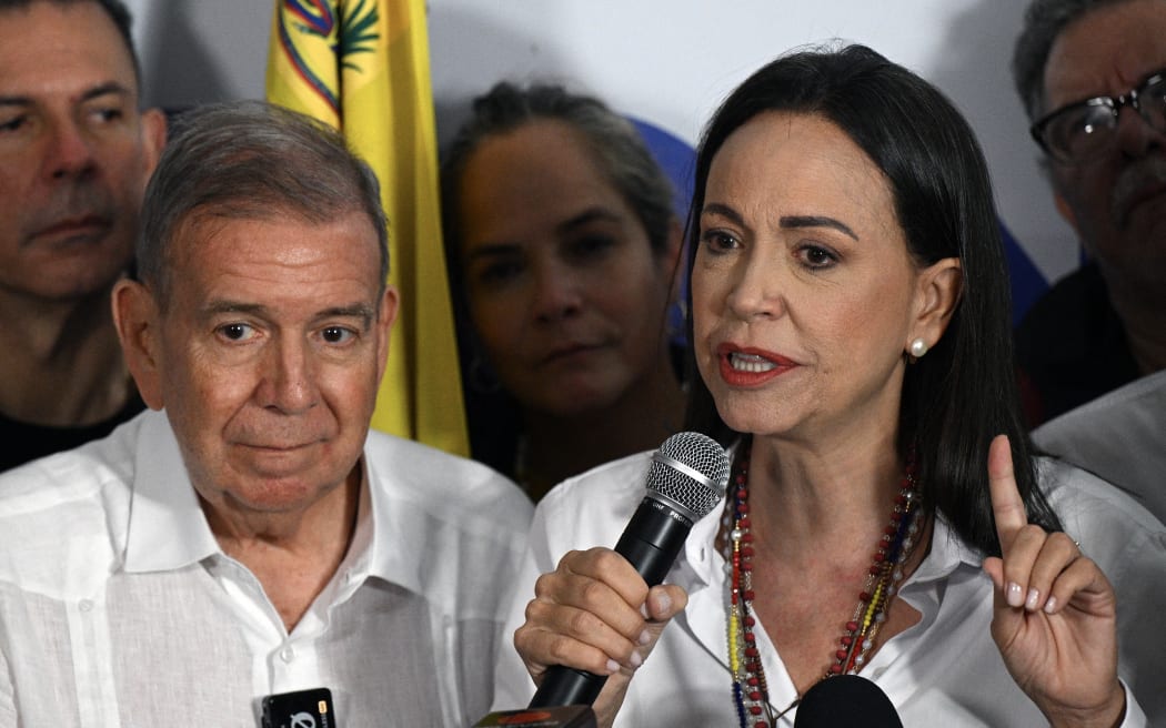 Venezuelan opposition leader Maria Corina Machado talks to the media next to opposition presidential candidate Edmundo Gonzalez Urrutia, following the presidential election results in Caracas on 29 July, 2024.