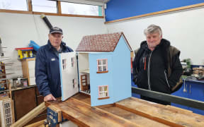 Bruce Nicol and Simon Chester with a dolls house a Cheviot MenzShed member has made
