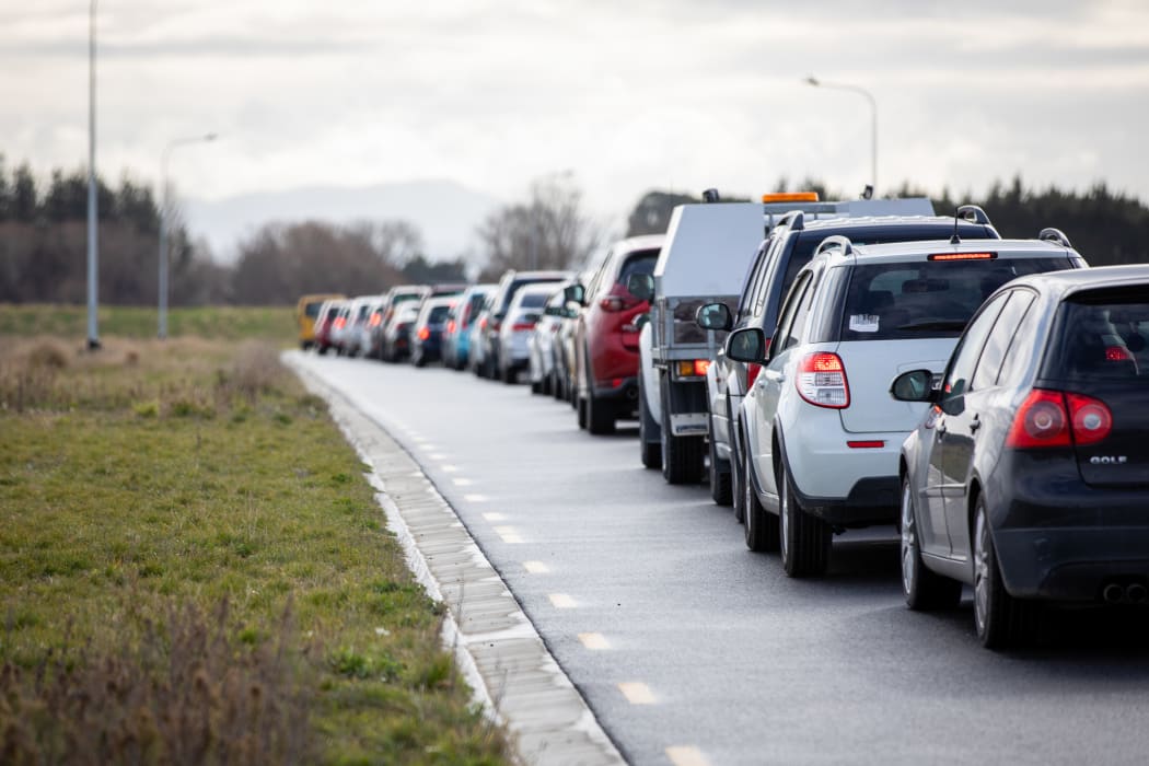 Cars line up as people wait to be tested for Covid-19 at the Orchard Road drive-through testing centre in Christchurch