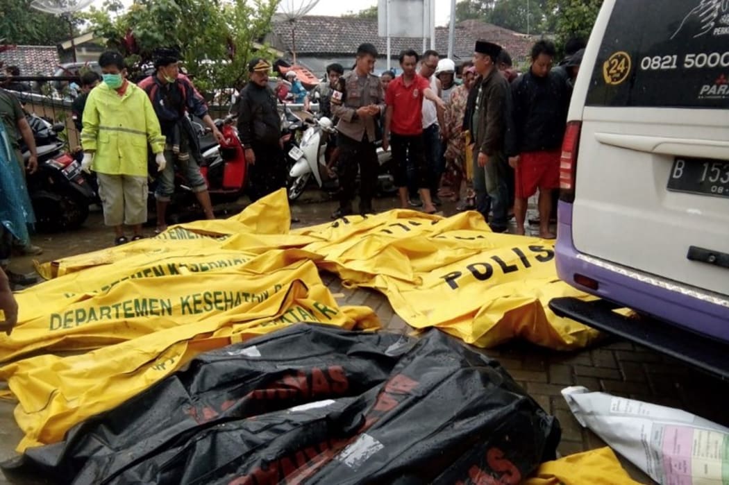 Bodies of victims recovered along Carita beach are placed in body bags on December 23, 2018, after the area was hit by a tsunami on December 22 following an eruption of the Anak Krakatoa volcano. AFP