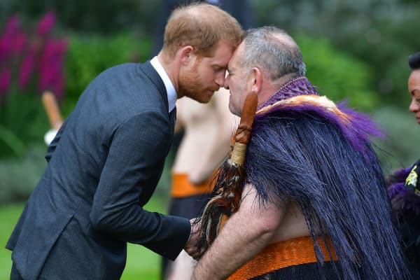 Britain's Prince Harry (L) receives a "hongi", or traditional Maori greeting, from an elder during an official welcoming ceremony at Government House in Wellington on October 28, 2018.