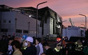 The fire-damaged lithium battery factory owned by South Korean battery maker Aricell is seen at dusk in Hwaseong on June 24, 2024. Twenty-two people were killed in a massive fire at a South Korean lithium battery plant on June 24, most of them Chinese nationals, in one of the country's worst factory disasters in years. (Photo by ANTHONY WALLACE / AFP)