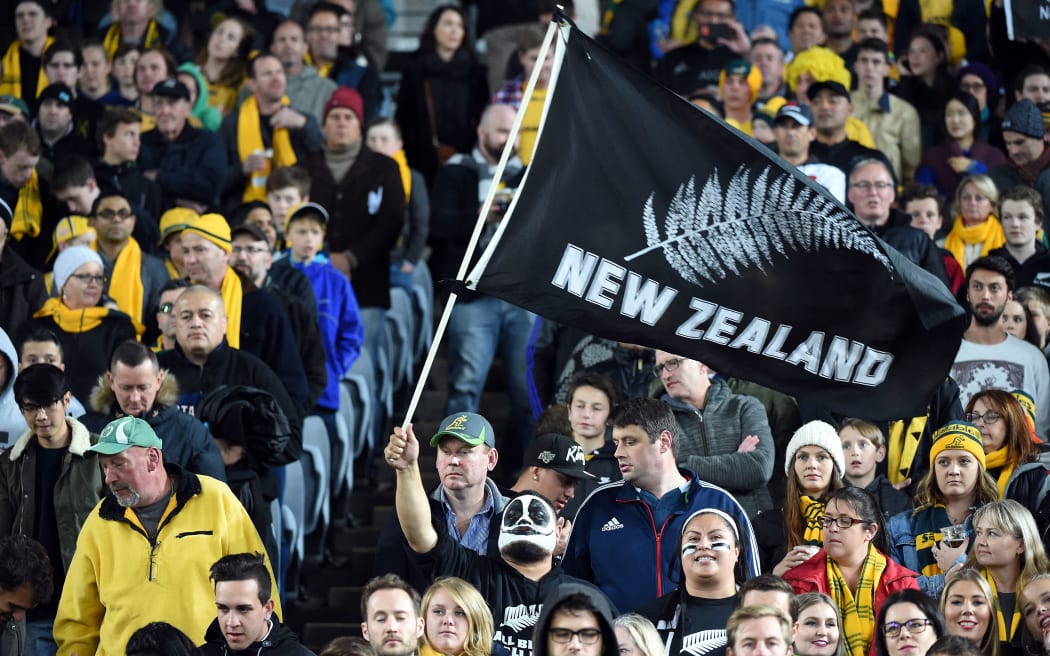 Supporters of the New Zealand women's hockey team cheer on their players 24 September 2000 during the preliminary Olympic hockey match between New Zealand and Australia at the State Hockey Centre in Sydney