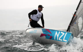 July 31, 2012  Mens Finn - Dan Slater (NZL) on a big sea in Race 1, Mark 1