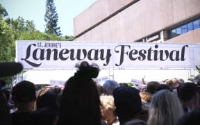 Patrons queue in the sun at the entrance to the Laneway Festival this afternoon.