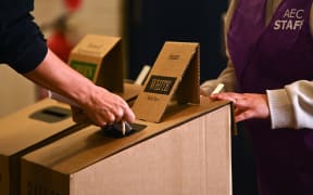 A voter casts their ballot during Australia's general election at a polling station at Bondi Beach in Sydney on May 21, 2022.