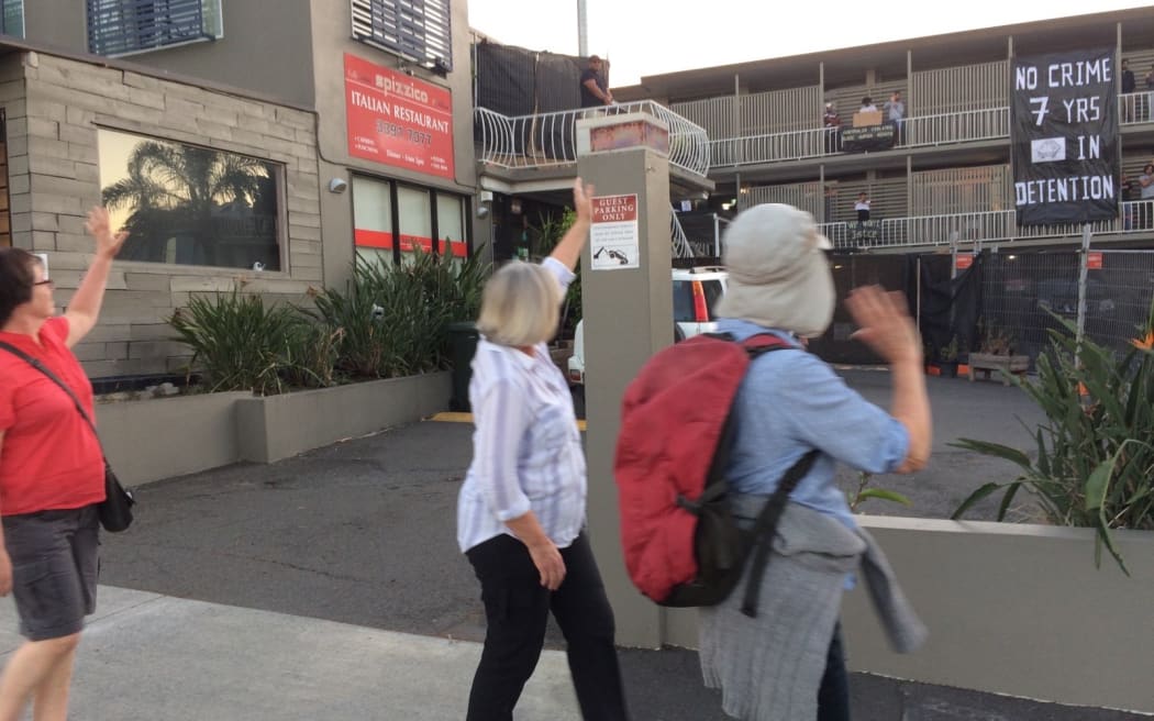 Protesters wave to refugees protesting in the Brisbane APOD.