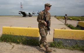 A US soldier walks at the Qayyarah air base, where US-led troops in 2017 had helped Iraqis plan out the fight against the Islamic State in nearby Mosul in northern Iraq, before a planned US pullout on March 26, 2020.