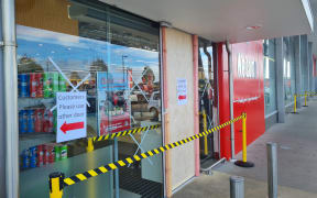 The entry to New World in Wigram, bordered up after its doors were smashed with an axe.