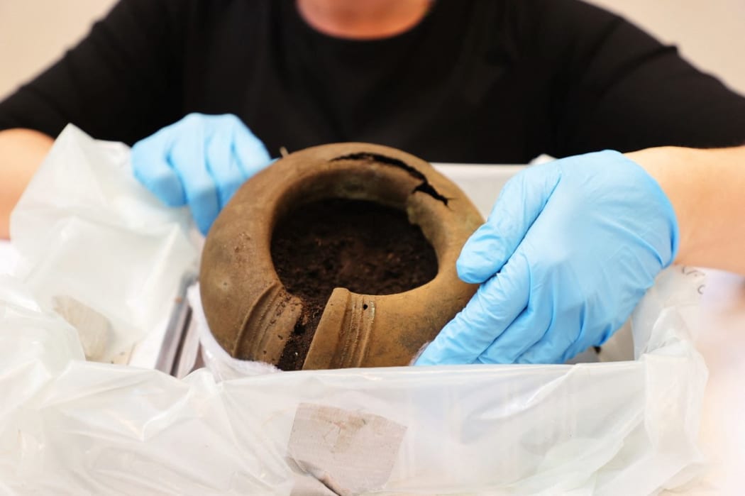 Madelene Skogbert, curator, shows a bone ring. Necklaces, foot rings, chains and other objects from the Late Bronze Age which have been found in an archaeological survey south of Alingsås shown in Gothenburg, Sweden, on April 29, 2021.