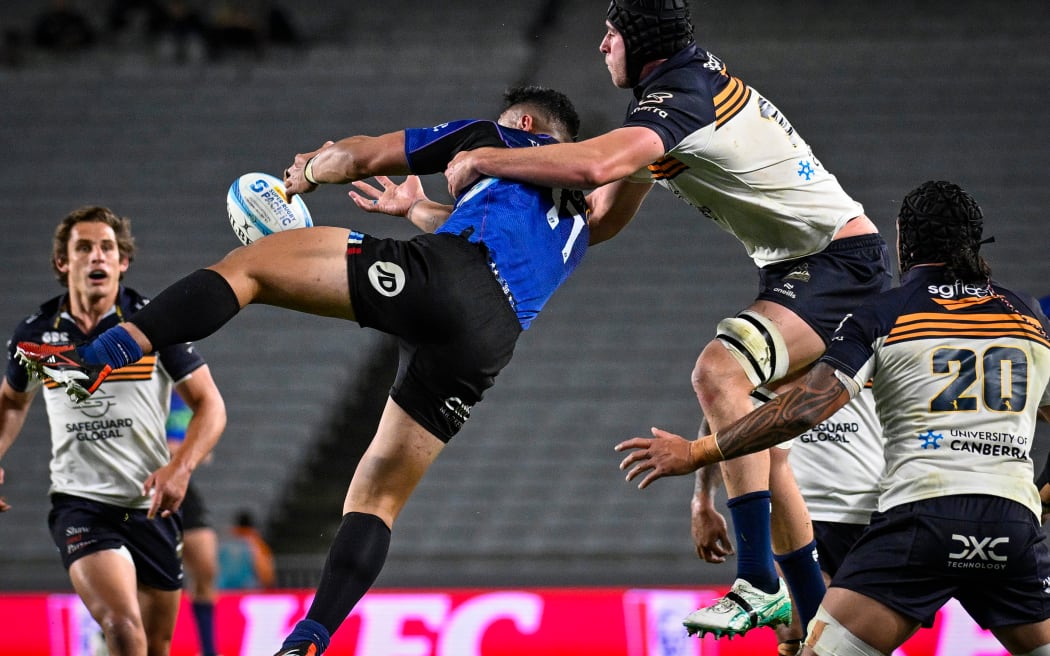 Caleb Clarke of the Blues and Nick Frost of the Brumbies contest possession during their Super Rugby Pacific semi-final at Eden Park.