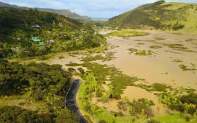 Residents of Te Henga Bethells Beach have no access to the only road out of the area after flooding in the area.
