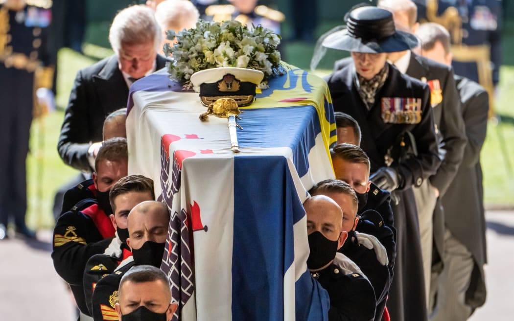 Pall Bearers carry the coffin of Britain's Prince Philip, Duke of Edinburgh, followed by members of the Royal family inside St George's Chapel in Windsor Castle in Windsor, west of London, on April 17, 2021.