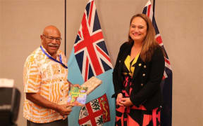 Fiji prime minister Sitiveni Rabuka receives gift from Carmel Sepuloni, including a book written by her husband at the Pacific Islands Forum Special Leaders Retreat in Nadi, February 2023.