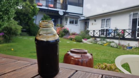 Jar of oil from an abandoned well underneath Daveena Dawrant's backyard.