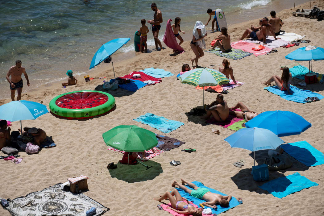 People enjoy a day out at the beach in Platja d'Aro