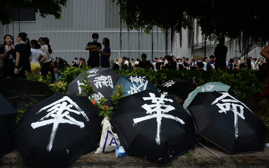 Demonstrators used umbrellas to shield themselves from pepper spray.