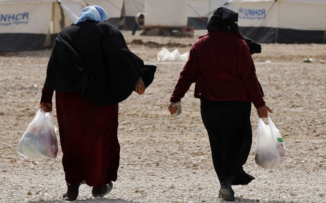 Syrian refugees leaving a World Food Programme market at a refugee camp in the Jordanian city of Mafraq.