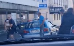 David Allan Devenport, pictured in the blue polo shirt at the rear of his vehicle, watched as a member of the public removed his dog from his car.