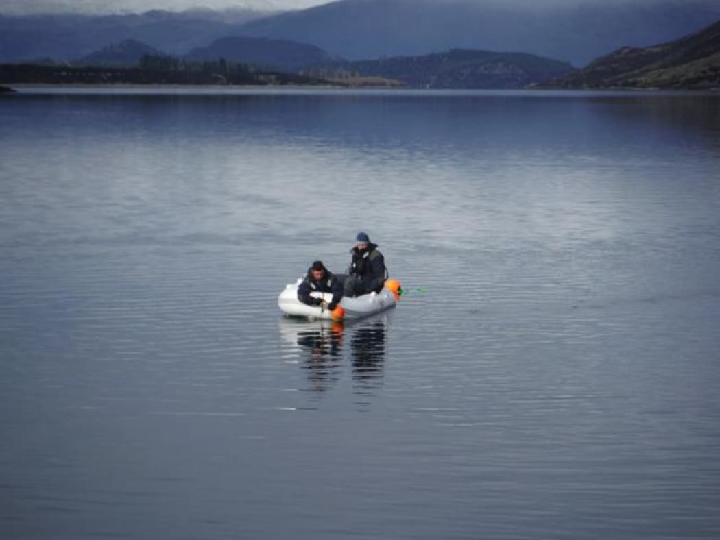Police-led search specialists on Lake Wanaka during the operation to recover the body of crashed pilot Matt Wallis.