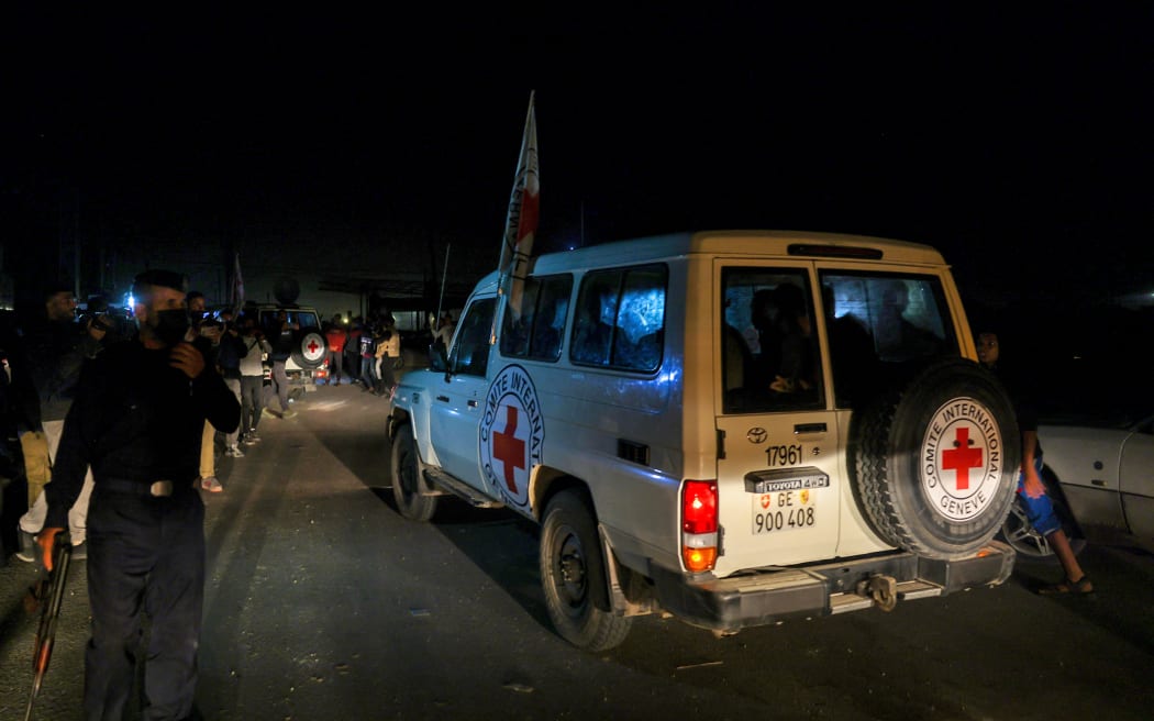 International Red Cross vehicles reportedly carrying hostages released by Hamas on 24 November, cross the Rafah border point in the Gaza Strip on the way to Egypt, before being flown to Israel.