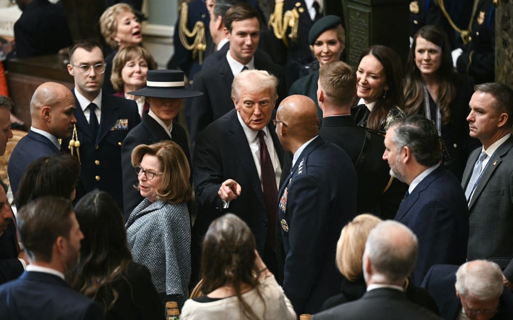 US President Donald Trump gestures as he departs a luncheon following the inauguration ceremony, in Statuary Hall at the US Capitol in Washington, DC, on January 20, 2025. (Photo by Brendan SMIALOWSKI / AFP)