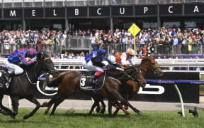Jockey Craig Williams onboard Vow and Declare, followed by Frankie Dettori on Master of Reality and and at the far left, Michael Walker on Prince of Arran.