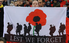 World Cup Qualifying Football. England versus Scotland. A fan Remembers with a poppy banner.
