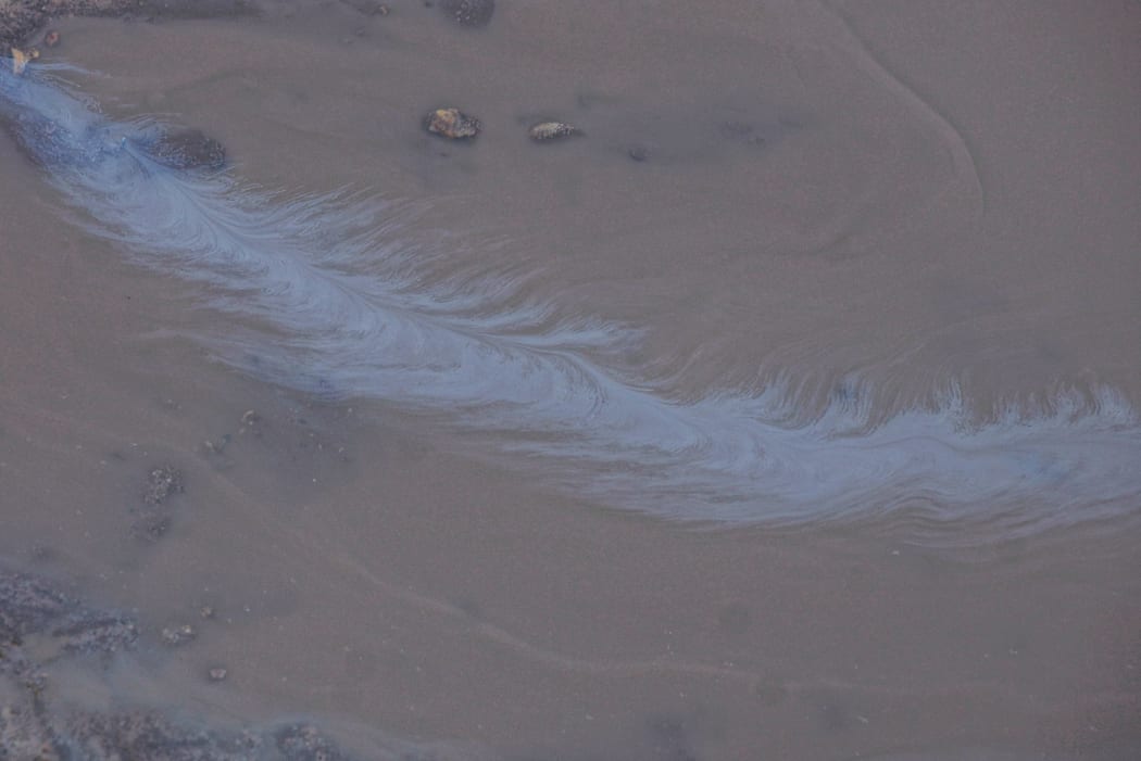 An oil slick is being dealt with off Woolshed Bay.