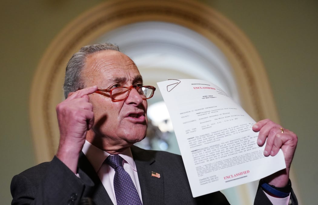 Senate Minority Leader Chuck Schumer (D-NY) speaks to reporters as he holds a transcript of the phone call between US President Donald Trump and Ukraine President Volodymyr Zelensky.