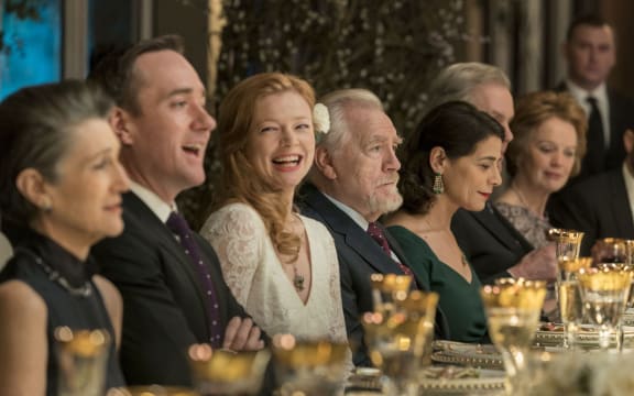 Logan Roy (Brian Cox) prepares to toast at the wedding of his daughter Shiv (Sarah Snook) to Tom (Matthew McFadyen), flanked by his second wife (Harriet Walter) and his third (Hiam Abbas).