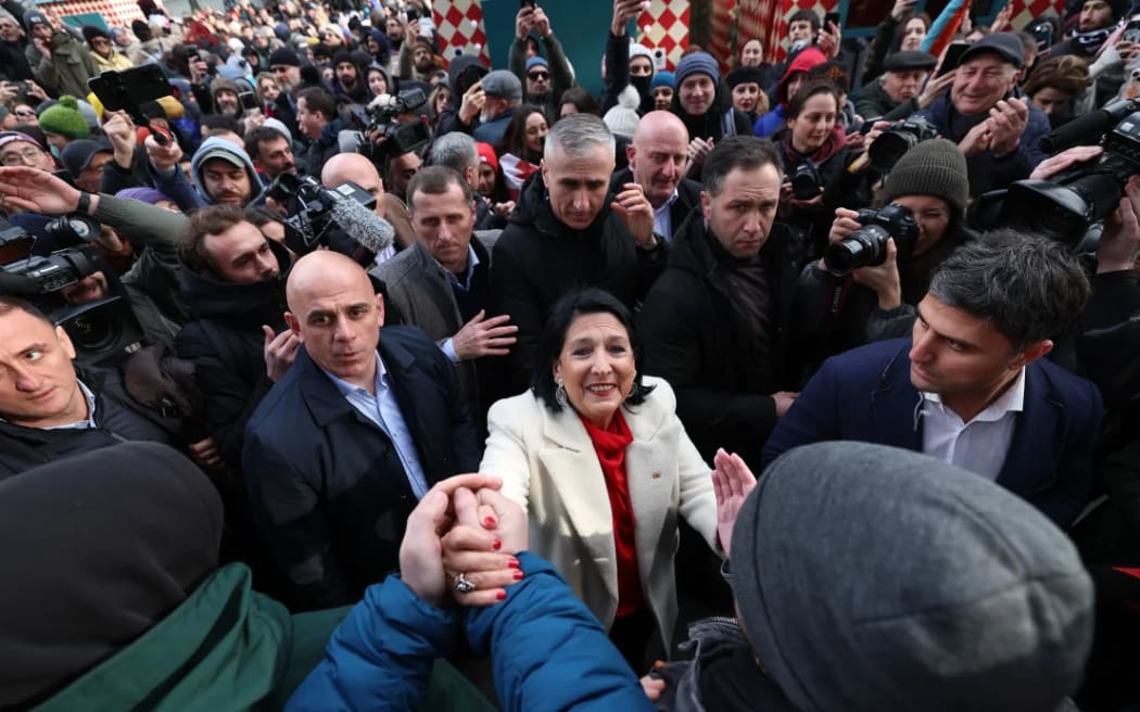 Georgia's outgoing pro-EU President Salome Zurabishvili (centre) condemned her anti-Western successor, telling supporters on Sunday: “I am taking legitimacy with me."
