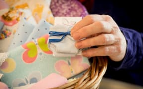 Hand made items include miniature nappies.