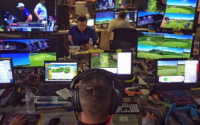 Reece Witters in the foreground operating Virtual Eye Flight Track technology at the US Open (Supplied)