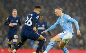 Manchester City forward Erling Haaland (R) in action against Chelsea.