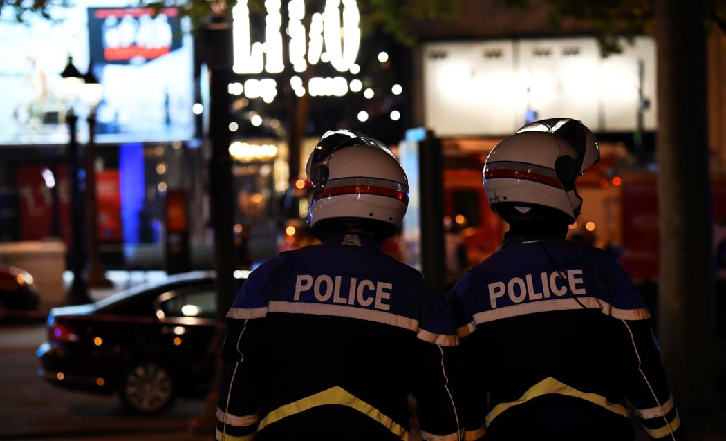 Police officers patrol on the Champs-Elysees