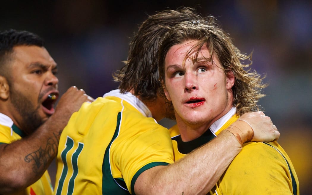 Bloodied Wallabies skipper Michael Hooper celebrates the win over the Boks