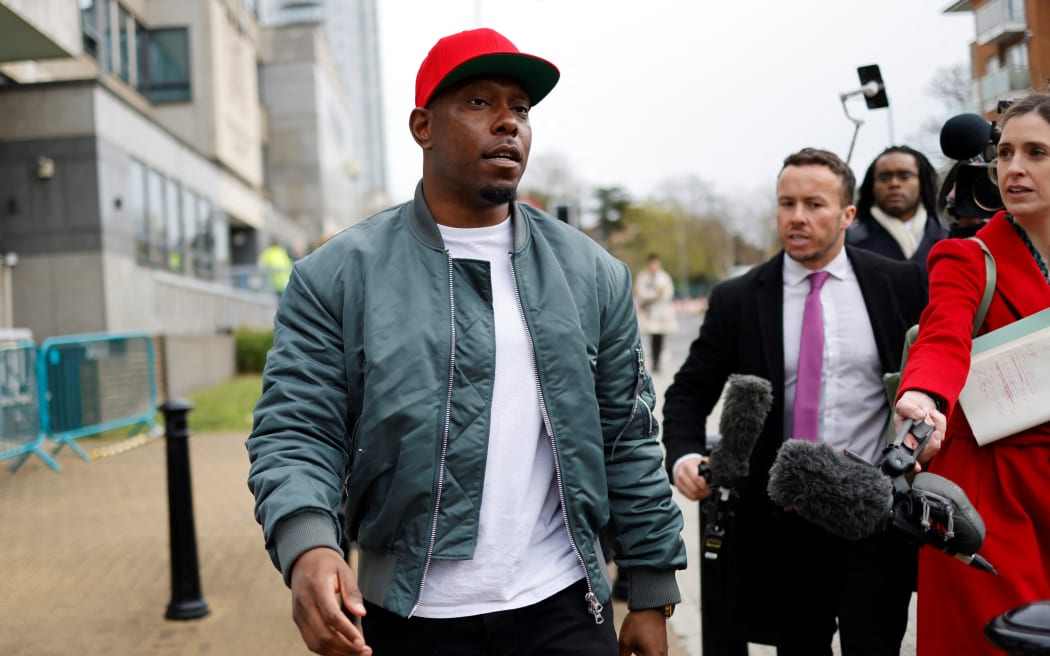 British rapper Dizzee Rascal speaks to the media as he leaves the Croydon Magistrates’ Court in London, on April 8, 2022 following the sentence on his trial for assaulting his ex-fiancee.