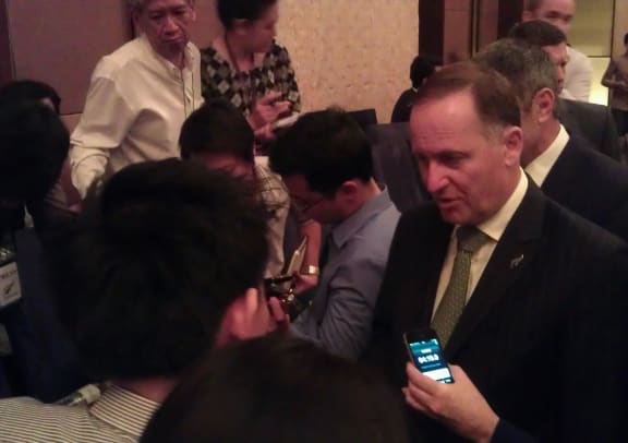 John Key speaking to media in Bangkok.